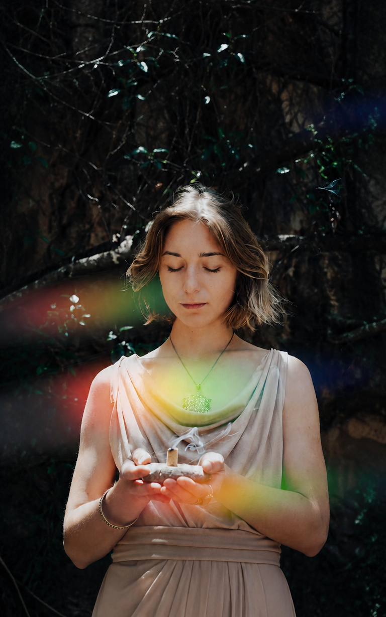 Olga holding incense, centered portrait in forest