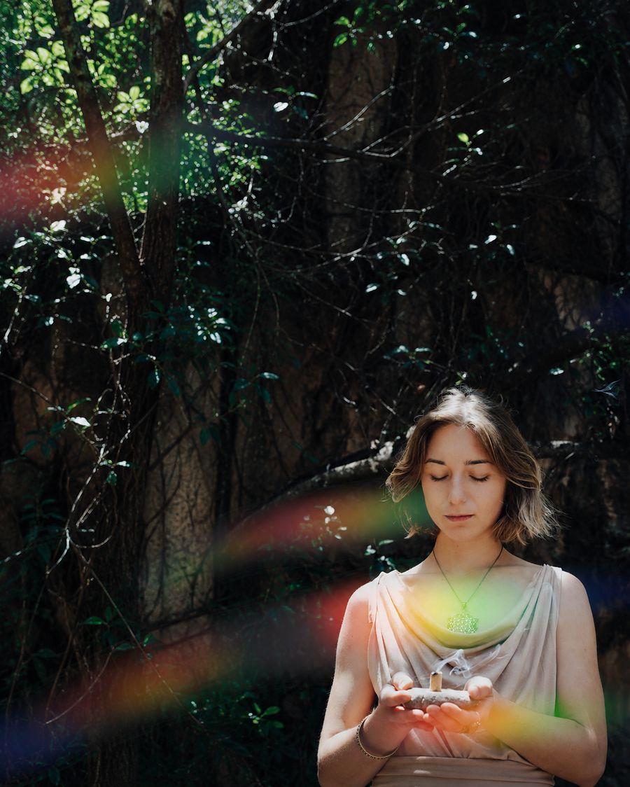 Olga holding incense, centered portrait in forest